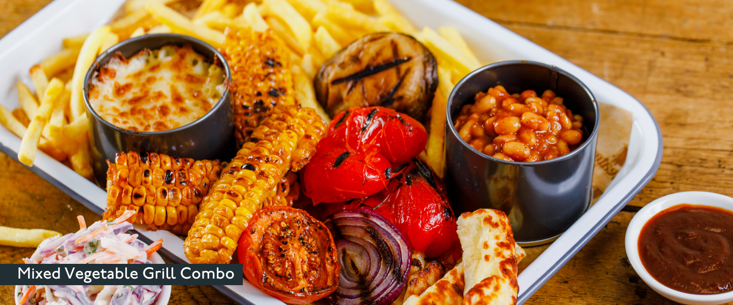 Beefeater Mixed Vegetable Grill Combo with tomatoes, peppers, halloumi, beans, sweetcorn, a pot of coleslaw and a BBQ&nbsp;dipping&nbsp;sauce.